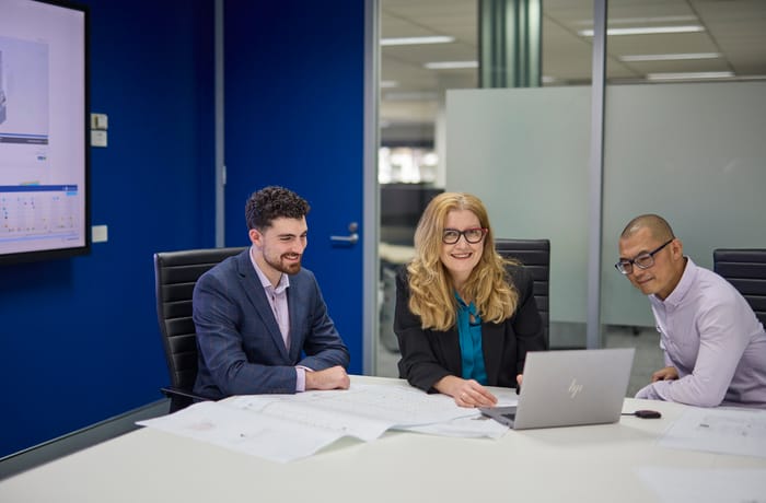 Three Employees in a broadroom