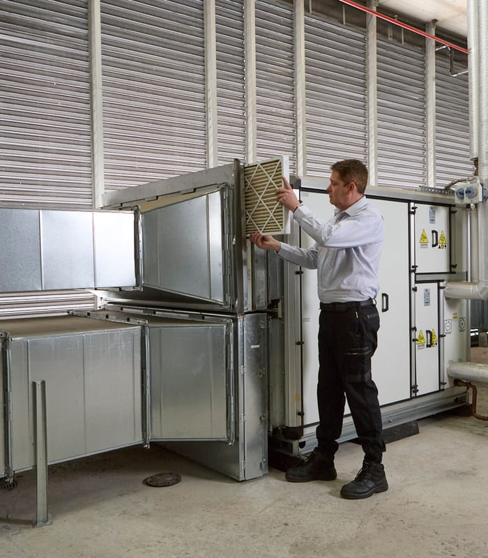 A man in front of machinery